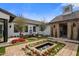 A beautiful backyard featuring a water fountain, seating area and colorful landscaping at 7508 E Laredo Ln, Scottsdale, AZ 85250
