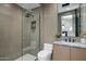 Well-lit bathroom featuring glass enclosed shower, stylish fixtures and vanity with marble countertop at 7508 E Laredo Ln, Scottsdale, AZ 85250