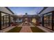 Charming courtyard with brick pathway, manicured lawn, water feature, and cozy outdoor seating at 7508 E Laredo Ln, Scottsdale, AZ 85250