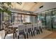 Modern dining area with a large table, wine storage, expansive windows, stylish chairs, and contemporary lighting at 7508 E Laredo Ln, Scottsdale, AZ 85250