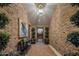 Stunning entryway featuring brick walls, modern lighting, and decorative plants at 7508 E Laredo Ln, Scottsdale, AZ 85250