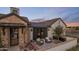Charming exterior featuring brick accents, a cozy seating area, and manicured landscaping at 7508 E Laredo Ln, Scottsdale, AZ 85250