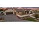 A home featuring a large driveway, two car garage, brick accents, and manicured landscaping at 7508 E Laredo Ln, Scottsdale, AZ 85250