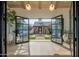 Grand foyer with herringbone floors, open glass doors and views of the courtyard at 7508 E Laredo Ln, Scottsdale, AZ 85250