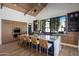 The modern kitchen showcases a spacious island, custom wood cabinetry, stainless steel appliances, and sleek design at 7508 E Laredo Ln, Scottsdale, AZ 85250