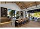 Beautiful kitchen with a large island with seating, wood cabinets, expansive window and view to the outdoor patio at 7508 E Laredo Ln, Scottsdale, AZ 85250