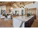 This inviting open-concept kitchen flows into the living room, complete with a large island and high-end appliances at 7508 E Laredo Ln, Scottsdale, AZ 85250