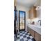 Well-appointed laundry room with modern washer and dryer and checkerboard tile floors at 7508 E Laredo Ln, Scottsdale, AZ 85250