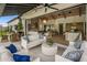 Open living room with modern furnishings, wood ceiling beams, and an seamless indoor-outdoor flow at 7508 E Laredo Ln, Scottsdale, AZ 85250