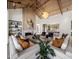 Stunning living room featuring a vaulted ceiling, fireplace, modern furnishings, and a stylish open-concept design at 7508 E Laredo Ln, Scottsdale, AZ 85250