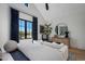 Bright main bedroom featuring hardwood floors, white walls and a large window with neighborhood views at 7508 E Laredo Ln, Scottsdale, AZ 85250