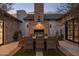 Inviting outdoor dining area with brick fireplace, stylish seating, and manicured landscaping at 7508 E Laredo Ln, Scottsdale, AZ 85250