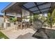 Luxurious outdoor living space featuring a built-in outdoor kitchen, dining area, and swimming pool at 7508 E Laredo Ln, Scottsdale, AZ 85250