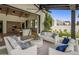 Covered patio with comfortable seating and views of the gourmet kitchen and manicured lawn at 7508 E Laredo Ln, Scottsdale, AZ 85250