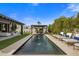 Stunning pool with water features, an outdoor seating area, and lush landscaping at 7508 E Laredo Ln, Scottsdale, AZ 85250
