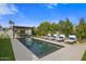 Beautiful pool area featuring lounge chairs, fountains, and a covered outdoor seating area at 7508 E Laredo Ln, Scottsdale, AZ 85250