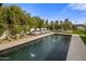 Inviting pool with lounge chairs, lush landscaping, and a serene atmosphere at 7508 E Laredo Ln, Scottsdale, AZ 85250