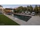Rectangular pool featuring manicured turf, in-pool fountains, and lounge seating at 7508 E Laredo Ln, Scottsdale, AZ 85250