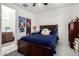 Bedroom featuring tile flooring, closet, and a wooden bed with a plush blue comforter at 7515 W Warner St, Phoenix, AZ 85043