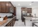 Kitchen featuring granite countertops, stainless steel appliances, and dark wood cabinetry at 7515 W Warner St, Phoenix, AZ 85043