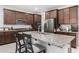 Kitchen with granite counters, a stainless steel refrigerator, and dark wood cabinets at 7515 W Warner St, Phoenix, AZ 85043