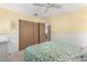 Bedroom featuring closet with wood doors and yellow painted walls and white trim at 7714 E Calypso Ave, Mesa, AZ 85208