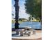 Park bench overlooking lake with water fountain feature at 7714 E Calypso Ave, Mesa, AZ 85208
