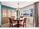 Inviting dining room featuring a classic chandelier and a beautiful built in cabinet with plenty of space at 7714 E Calypso Ave, Mesa, AZ 85208