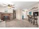 Open-concept living area featuring a fireplace, adjacent to the dining area and kitchen at 7714 E Calypso Ave, Mesa, AZ 85208