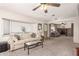 Bright living room with comfortable seating, an open layout, and natural light from large windows at 7714 E Calypso Ave, Mesa, AZ 85208