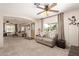 Spacious living room with ample seating and large windows, offering plenty of natural light at 7714 E Calypso Ave, Mesa, AZ 85208