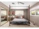 Bedroom with a canopy bed, side table, and lots of natural light from the window at 7714 E Calypso Ave, Mesa, AZ 85208
