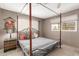 Bedroom with a canopy bed, side table, and lots of natural light from the window at 7714 E Calypso Ave, Mesa, AZ 85208