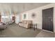 Sun room featuring dining table and seating area with neutral sofa and tile floors at 7714 E Calypso Ave, Mesa, AZ 85208