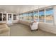 Sun room featuring neutral furnishings and many windows at 7714 E Calypso Ave, Mesa, AZ 85208