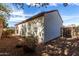 Backyard featuring a patio, block wall, desert landscaping and lots of mature trees at 7739 E Butte St, Mesa, AZ 85207