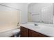 Neutral bathroom with a tub and shower combo, white sink, and dark wood cabinets at 7739 E Butte St, Mesa, AZ 85207