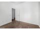 A large empty bedroom with neutral-colored carpet and trim, and lots of natural light at 7739 E Butte St, Mesa, AZ 85207