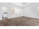 Cozy bedroom with a ceiling fan, and large windows at 7739 E Butte St, Mesa, AZ 85207