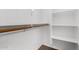 Bright closet features built-in shelving and a hanging rack for optimal storage at 7739 E Butte St, Mesa, AZ 85207