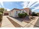 Lovely home exterior with desert landscaping, an extended driveway, and a detached garage at 7739 E Butte St, Mesa, AZ 85207