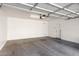 Spacious two-car garage features ample room for parking and storage with lighting at 7739 E Butte St, Mesa, AZ 85207