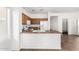 Kitchen view with breakfast bar, white appliances, and access to pantry and living areas at 7739 E Butte St, Mesa, AZ 85207