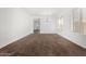 Inviting living area with neutral carpeting, large windows, and a chandelier at 7739 E Butte St, Mesa, AZ 85207