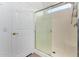 Walk-in shower with glass door and white tiled walls, adjacent to a doorway at 7739 E Butte St, Mesa, AZ 85207