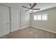 Bedroom with neutral walls, carpet flooring, ceiling fan, closet, and a window with plantation shutters at 8150 E Mitchell Dr, Scottsdale, AZ 85251