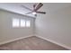 Bedroom with neutral walls, carpet flooring, ceiling fan, and a window with plantation shutters at 8150 E Mitchell Dr, Scottsdale, AZ 85251