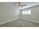 Neutral bedroom features carpet and a ceiling fan, with window shutters providing natural light at 8150 E Mitchell Dr, Scottsdale, AZ 85251