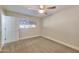 Carpeted bedroom with a window and fan provides a serene and inviting atmosphere at 8150 E Mitchell Dr, Scottsdale, AZ 85251