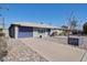 Well-kept home featuring a two-car garage and a neatly maintained front yard at 8150 E Mitchell Dr, Scottsdale, AZ 85251